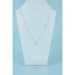 A 14ct gold white stone set pendant on 9ct gold chain with matching stud earrings,
