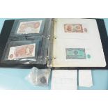 A folder containing British and world banknotes plus coins and a few Roman with paperwork