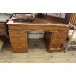 A c1940's oak nine drawer pedestal desk