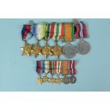 A group of six WWII medals including Atlantic and Pacific Stars with matching miniatures
