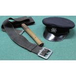 A fireman's axe within webbing belt and a cap bearing Lancashire County Brigade insignia