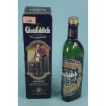 A bottle of Glenfiddich single malt whisky in tin,