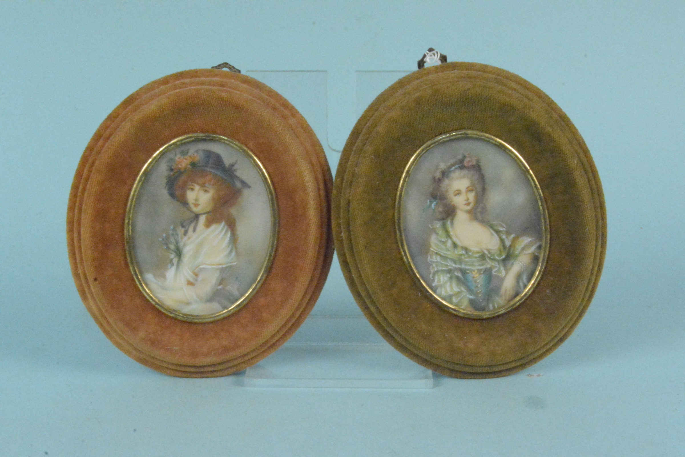 A pair of hand painted picture miniatures of ladies in early 19th Century costume,