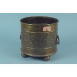 Aesthetic movement circular brass jardiniere with repousse decoration of fruit and flowers,