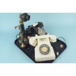 Two vintage Bakelite dial telephones plus a stick phone
