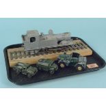 A vintage clockwork train that has been over painted in grey plus three Dinky military vehicles