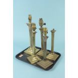 Five early 20th Century Corinthian column brass table lamps, all on stepped square bases,