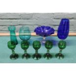A selection of coloured glasses including five green hock glasses with prunt decoration,