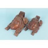 Two carved hardwood Eastern faces,
