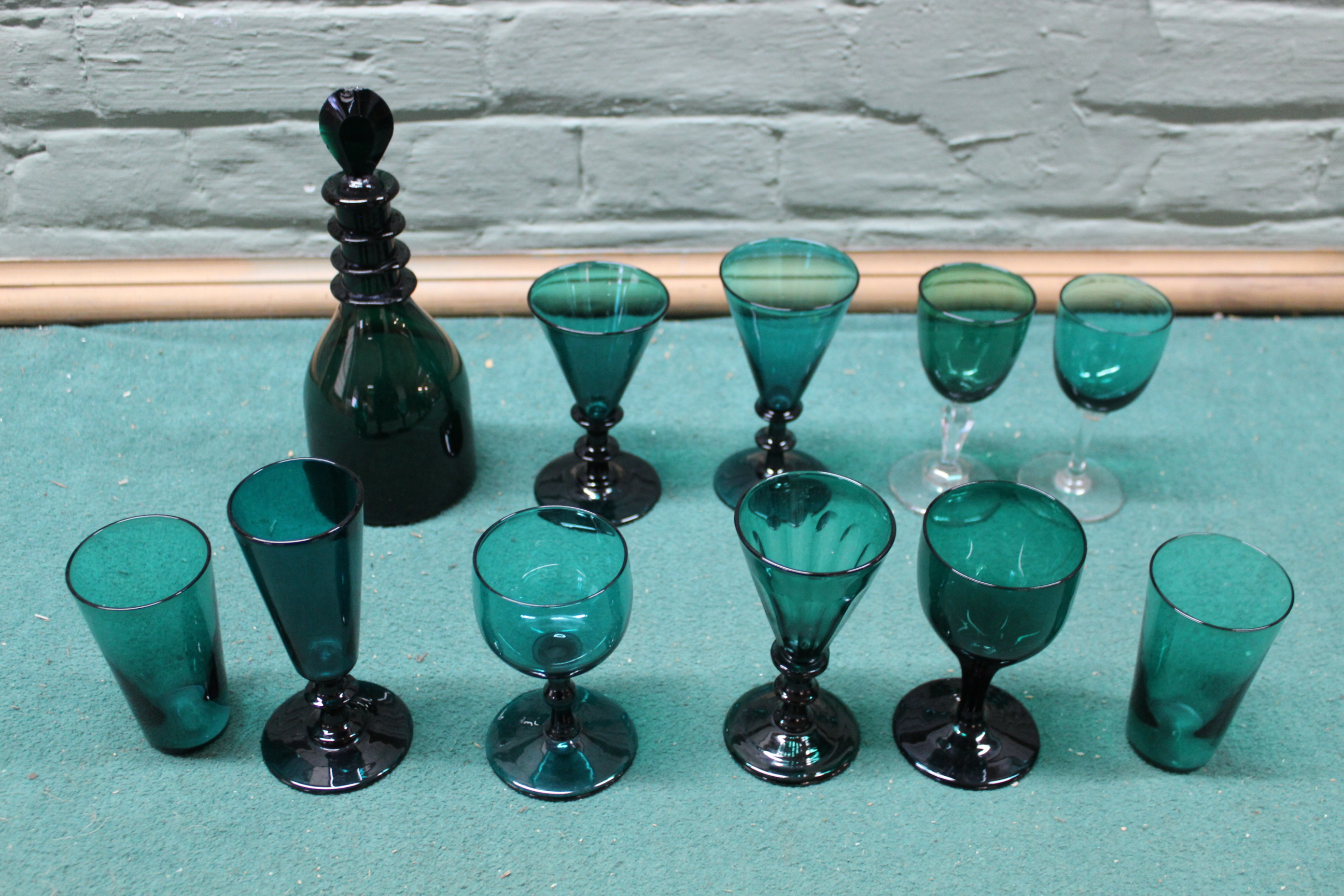 A selection of Victorian green glass including a small decanter plus various drinking glasses