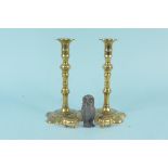 A pair of 19th Century brass petal base candlesticks with pushers,