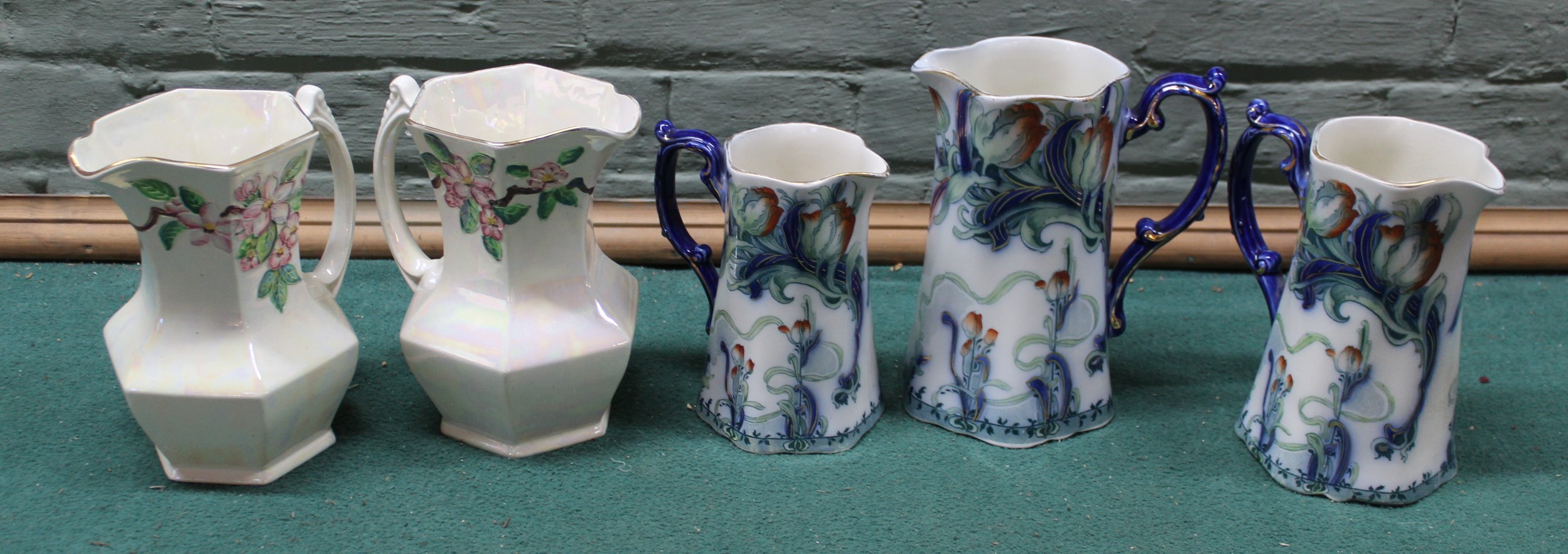 A graduating set of three 'Staffordshire' Art Nouveau jugs plus a pair of Maling ware Ringtons Ltd