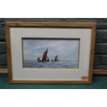 A framed watercolour of Thames barges at sea, signed 'Anthony Osler',