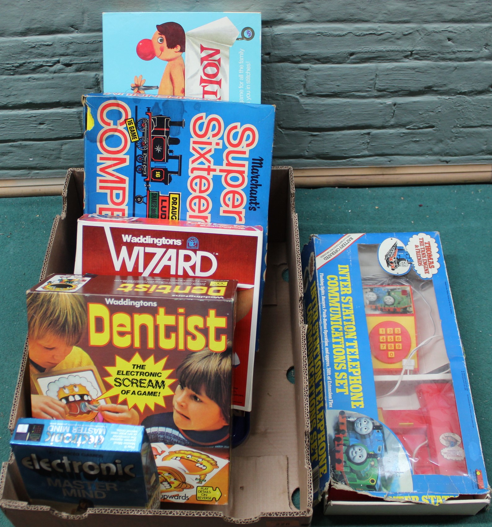 A selection of boxed games including Operation, Wizard,