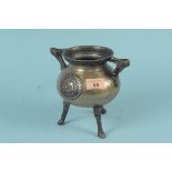 An antique miniature bronze cauldron, possibly 18th Century, with raised decoration to main body,