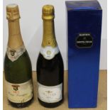 Two bottles of Brut sparkling wines and a boxed Harveys Bristol Cream sherry