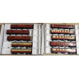 Two boxes with four trays each containing various Hornby Dublo tin plate carriages and odd tenders,