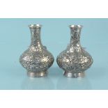 A pair of Chinese silver bud vases with embossed floral decoration,