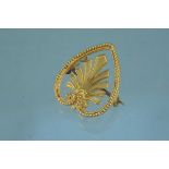 An unusual antique yellow metal heart form brooch with twisted edge detail and fan design centre,