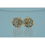 A pair of 9ct gold emerald set floral style earrings