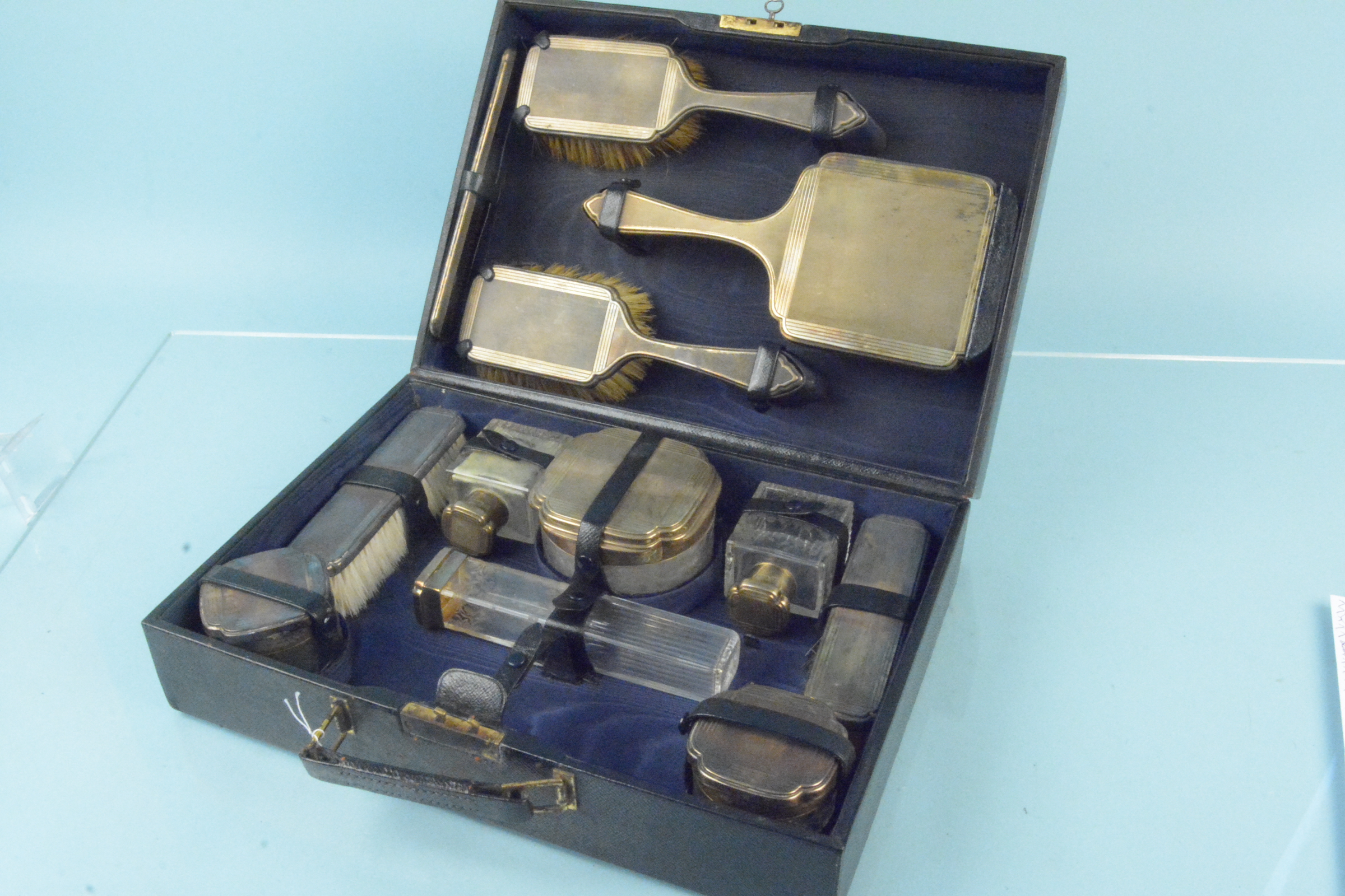 A good quality silver mounted glass vanity set with original leather fitted case,