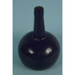 An early 19th Century blow-moulded green glass wine bottle