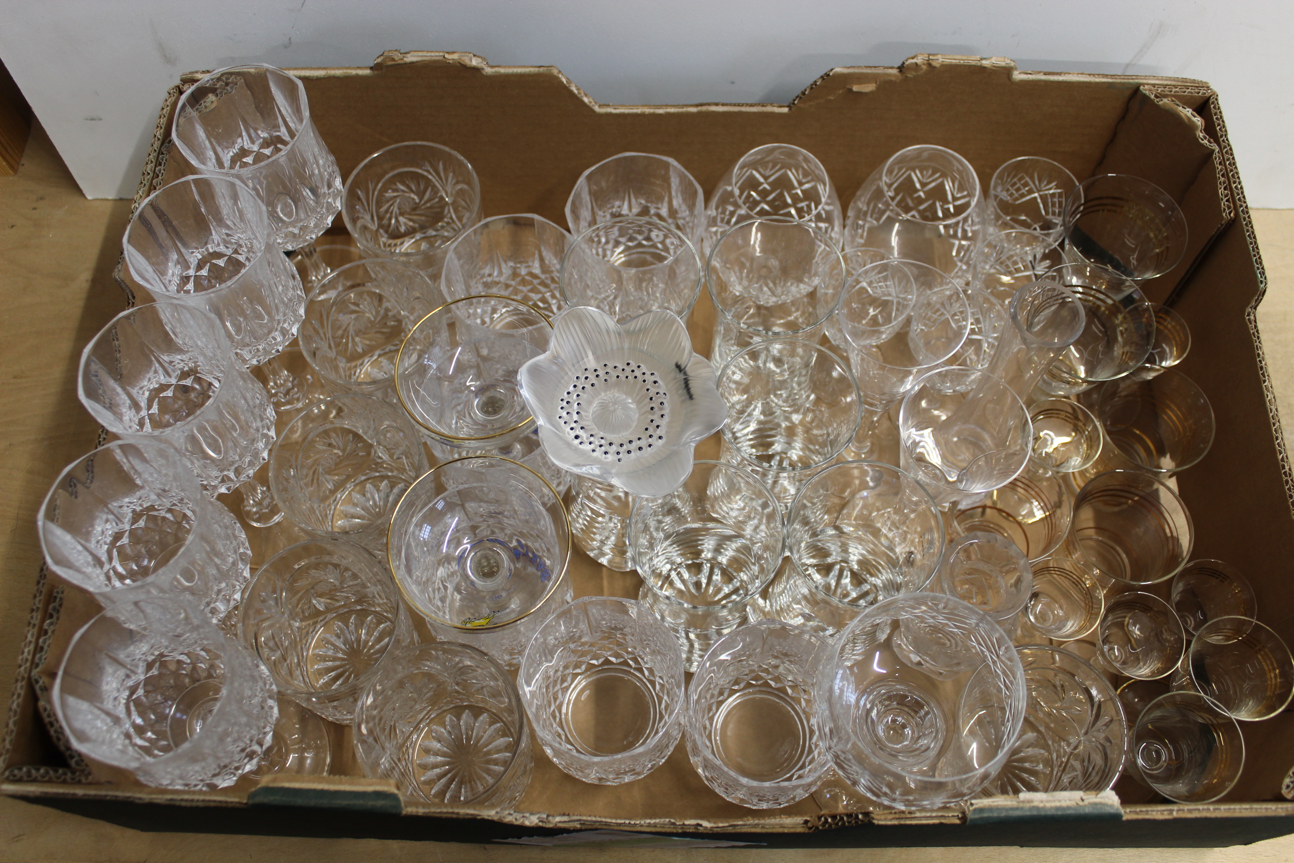 A large box of mixed drinking glasses including lead crystal and a Lalique Paris flower