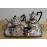 A silver plated two handled tray plus a four piece plated tea set