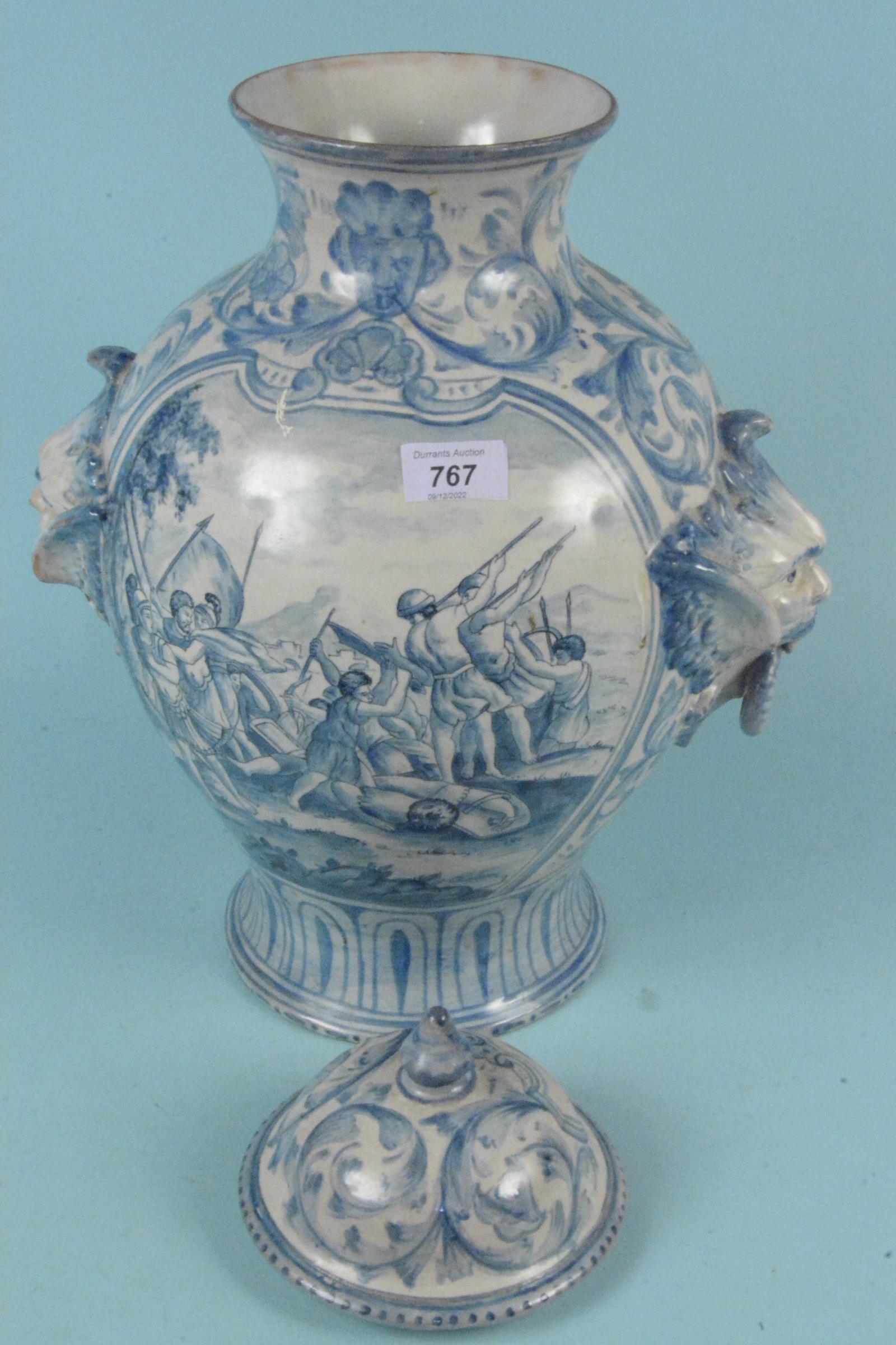 A large 19th Century Italian Majolica vase and cover with a painting of a battle scene with two