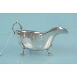 A silver sauce boat on three hoof feet (as found), hallmarked Chester 1911, maker Barker Brothers,
