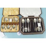 A cased set of six silver teaspoons and tongs with engraved initials plus a cased set of six silver