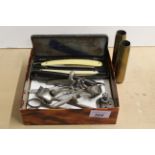 A vintage barbers set including cut throat razors and two shell cases