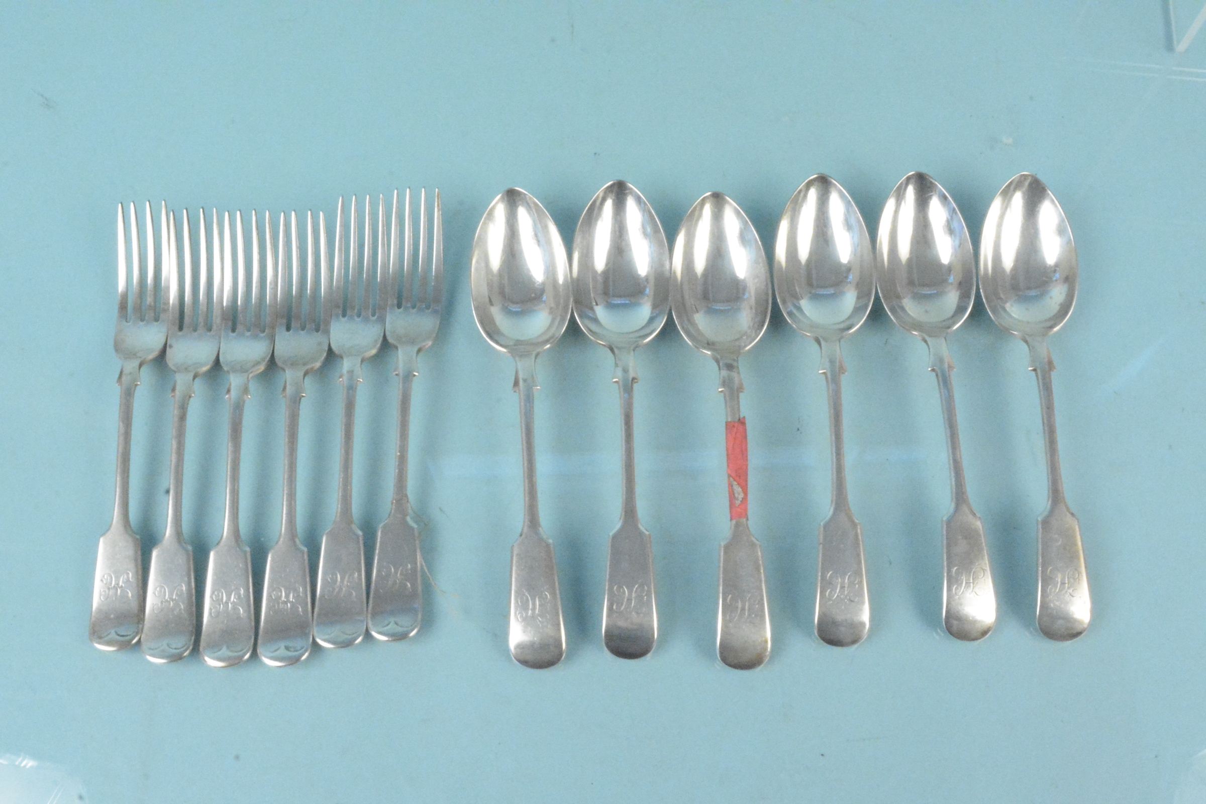 A set of six silver forks and spoons, hallmarked Birmingham 1900,