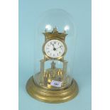 A brass torsion clock under glass dome