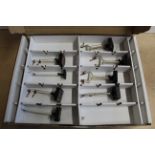 A box with two layers containing various Hornby signals, carriages,
