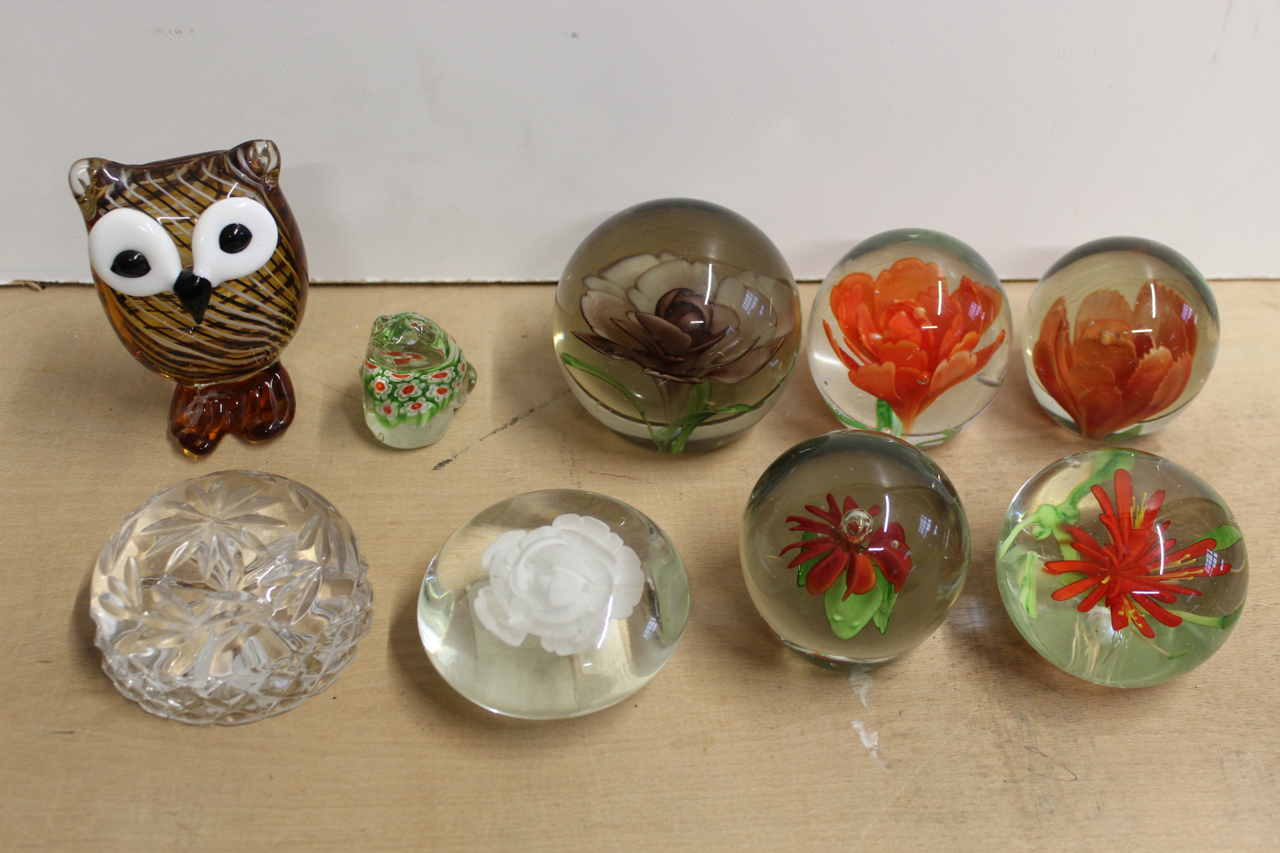 A selection of paperweights including an owl,