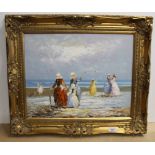A framed oil of a 19th Century style French beach scene with ladies and children paddling,