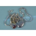 Five silver and white metal necklaces including a locket etc