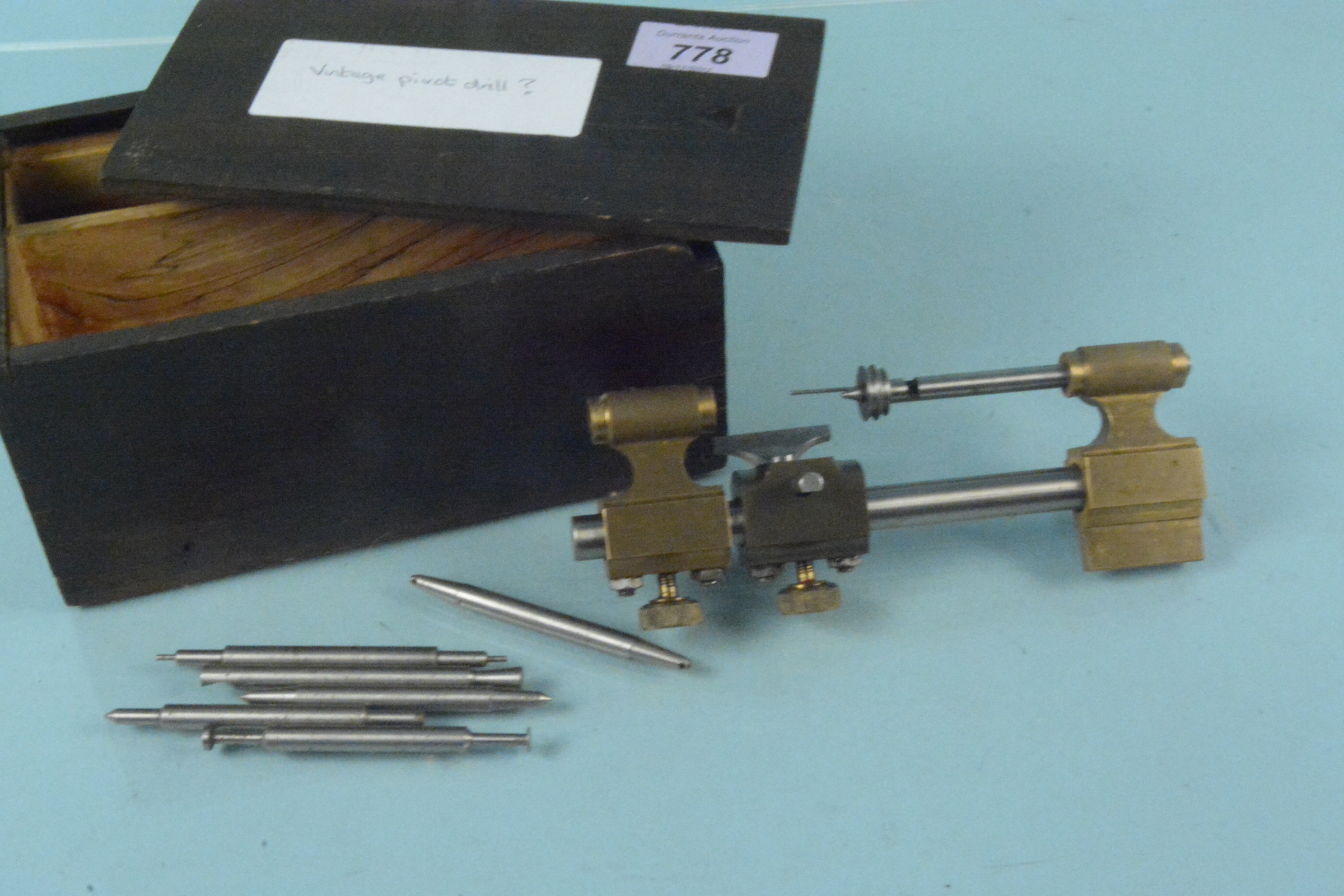 A late 19th Century brass watchmakers pivot drill with various accessories