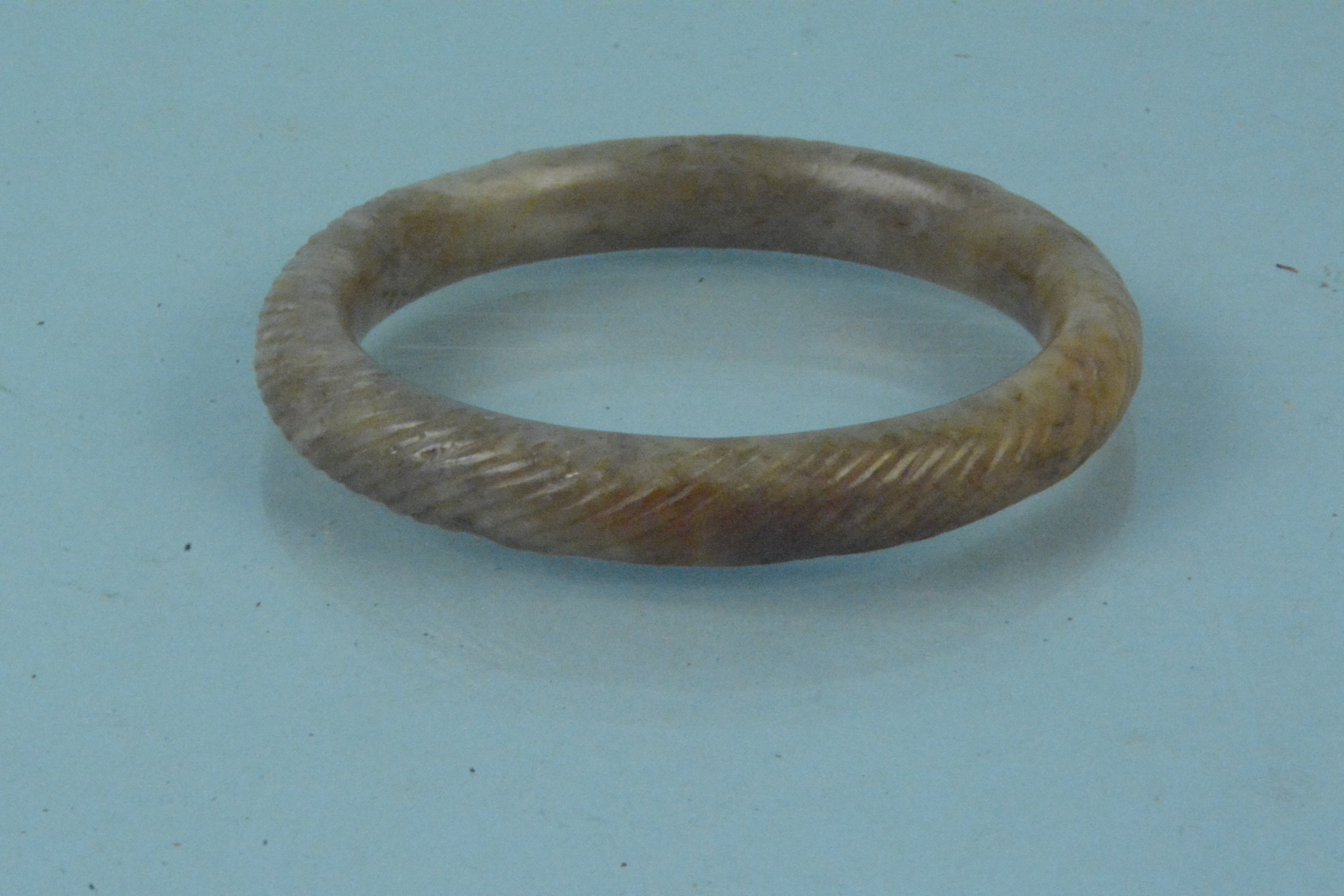 A jade bangle with engraved detail