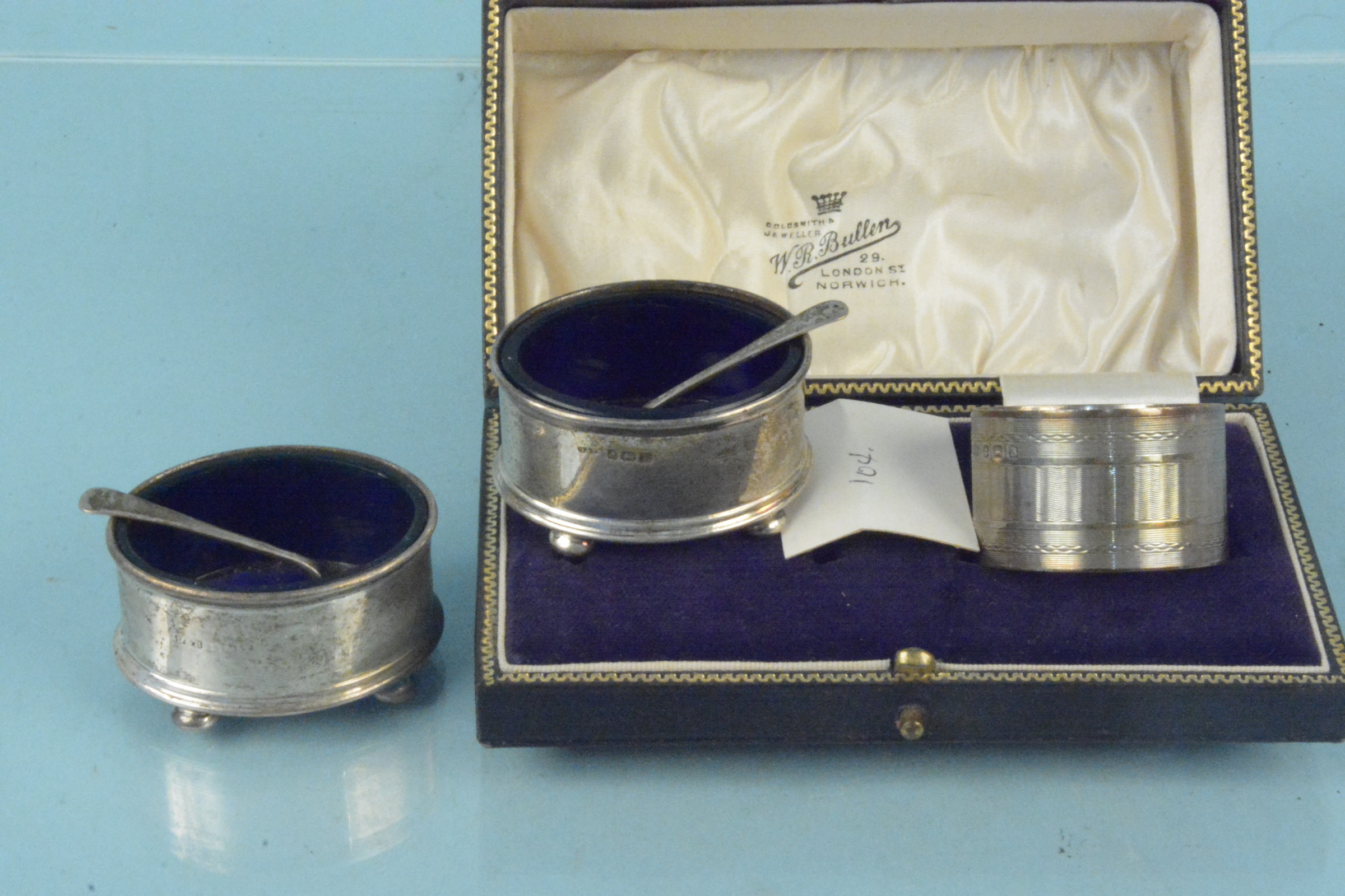 A collection of silver to include two oval salts with blue glass liners, spoons,