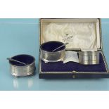 A collection of silver to include two oval salts with blue glass liners, spoons,