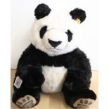 A Steiff panda, button and tag to ear,