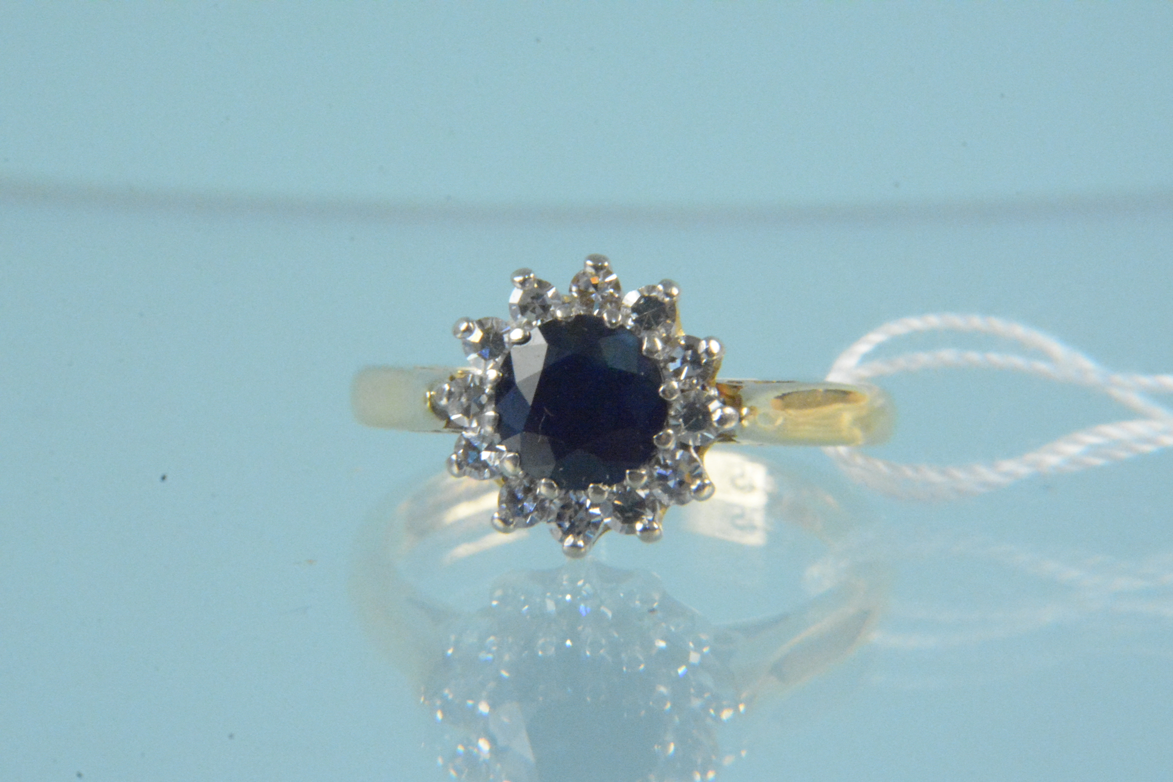 An 18ct gold sapphire and diamond cluster ring,