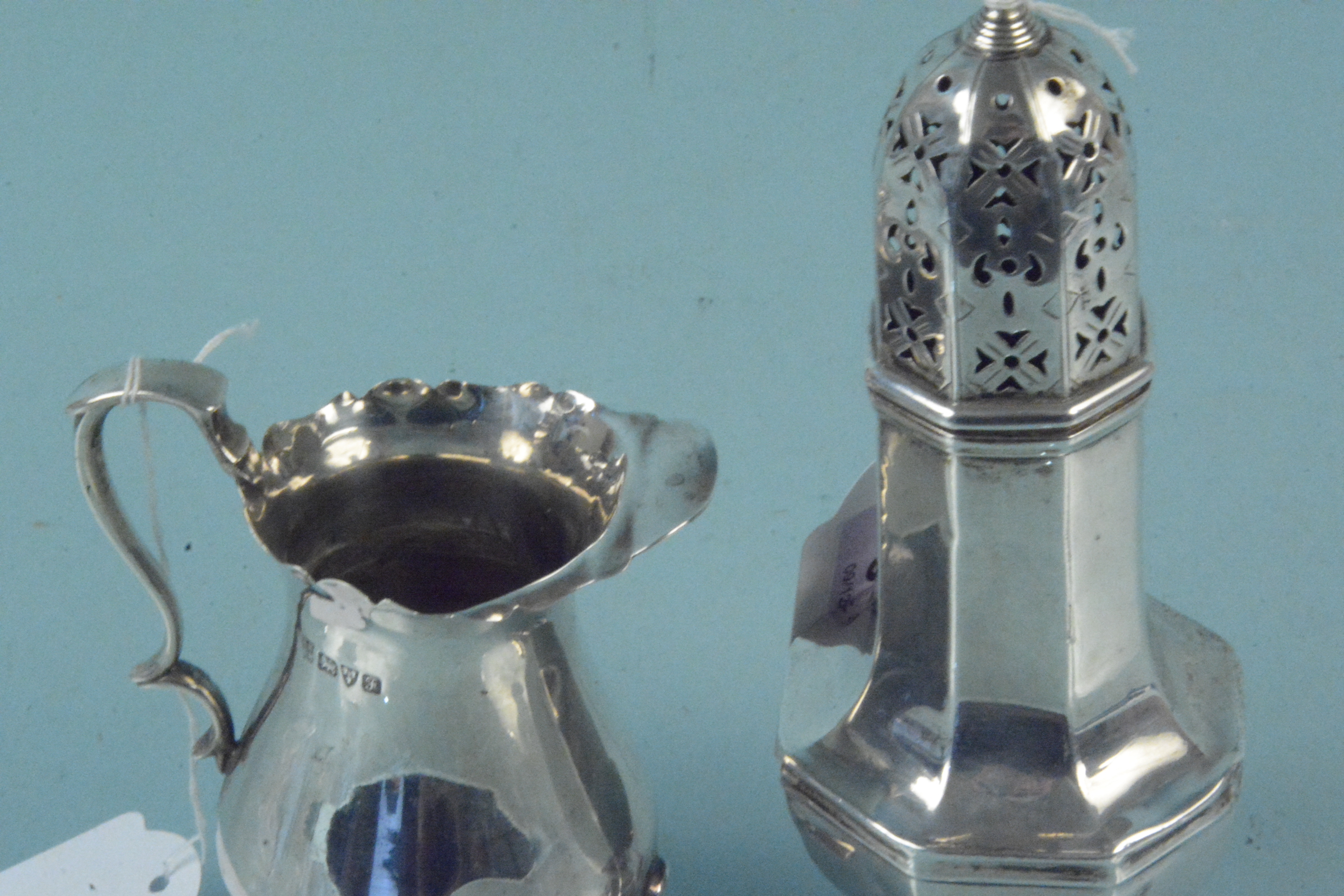 A silver sugar sifter (as found) plus a silver cream jug (as found), both hallmarked Chester 1906, - Image 2 of 3