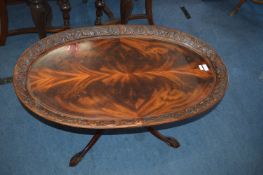 Oval Carved Mahogany Coffee Table with Ball & Claw Feet and Flame Veneered Top