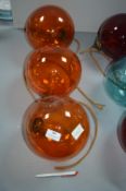 Three Orange Glass Pendant Lamps