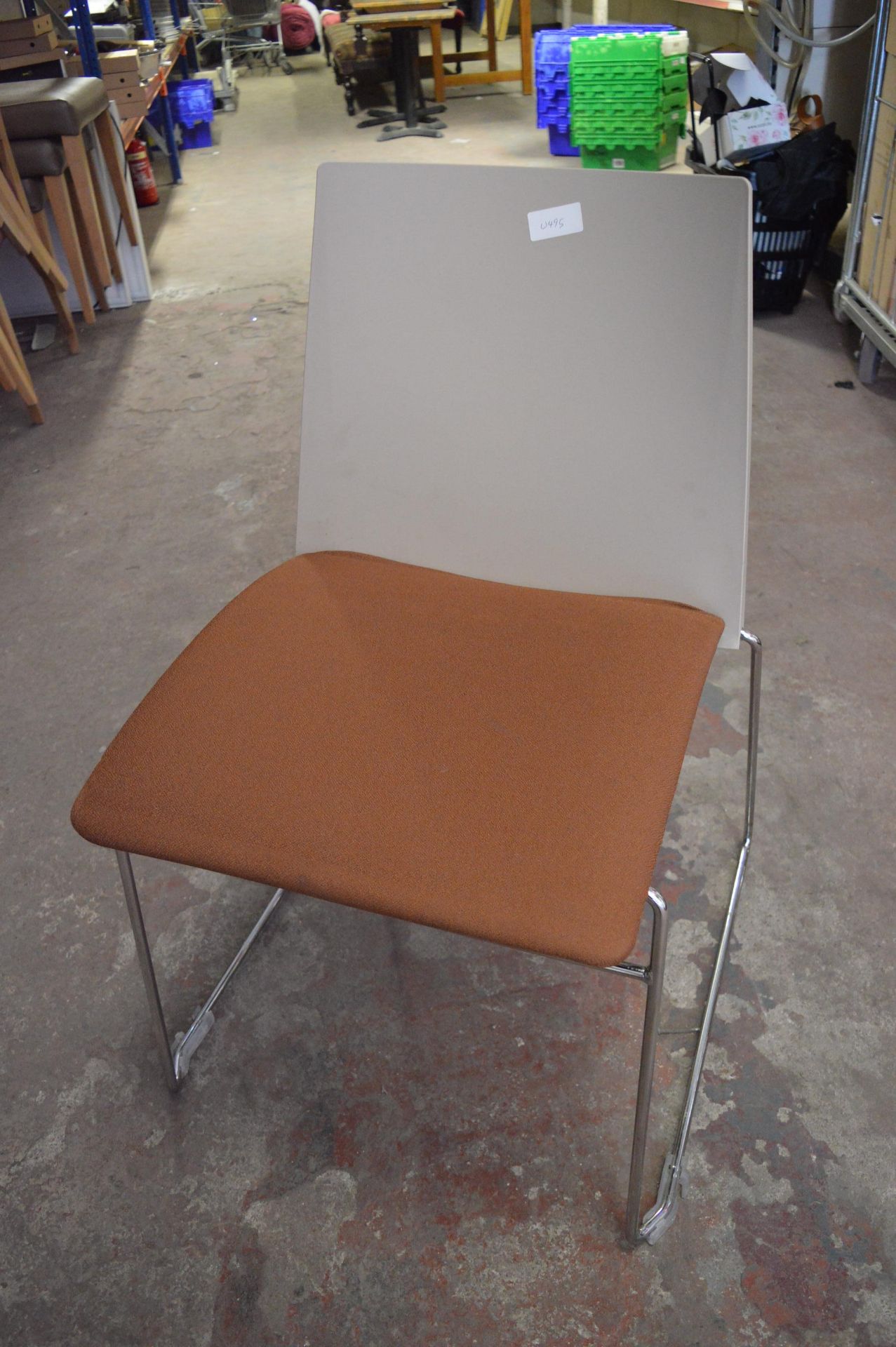 Ten Stackable Tubular Framed Chairs with Brown Upholstered Seats and Plastic Backs