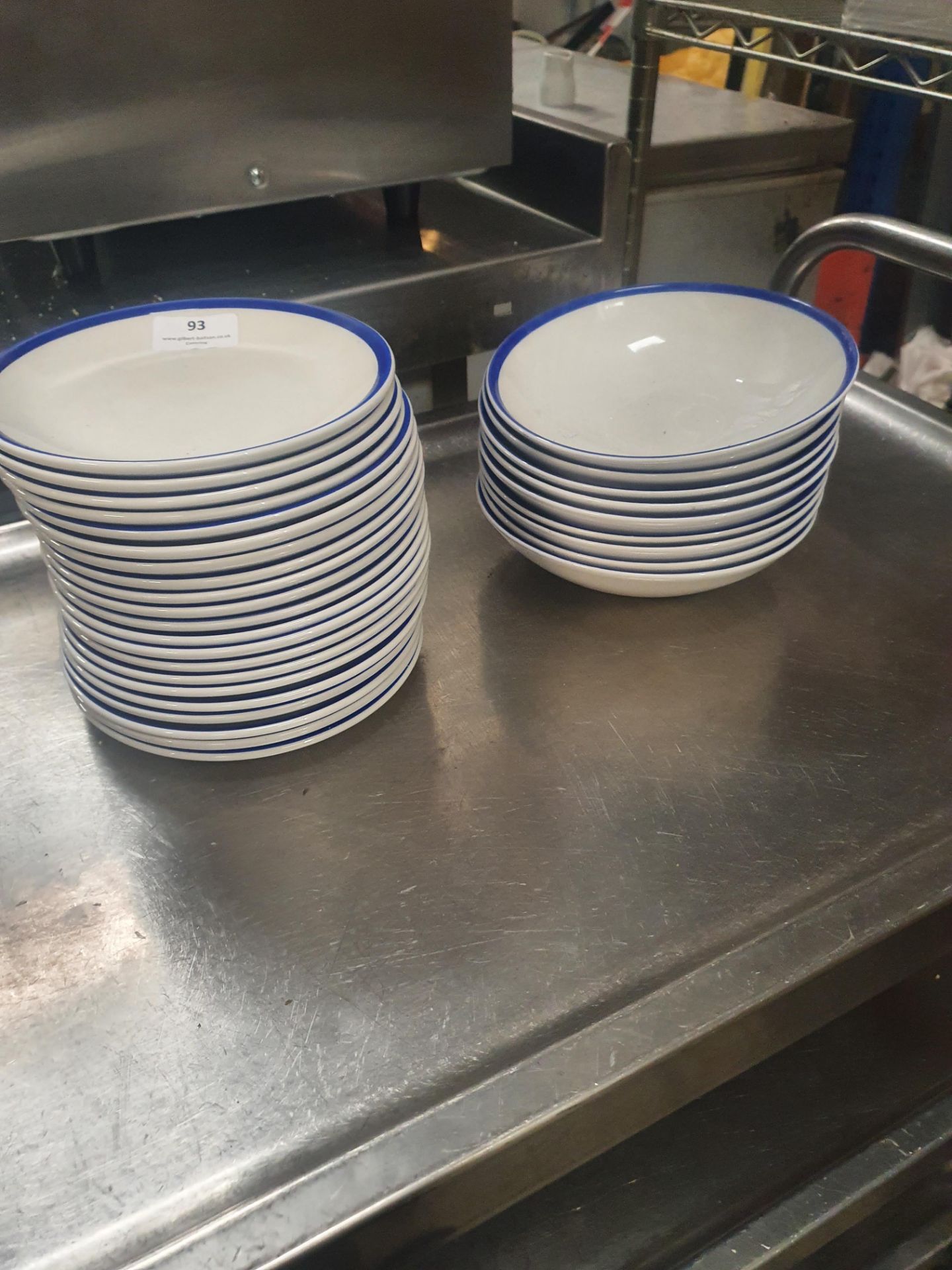 * approx 20 x plates and 10 x bowls with blue rim