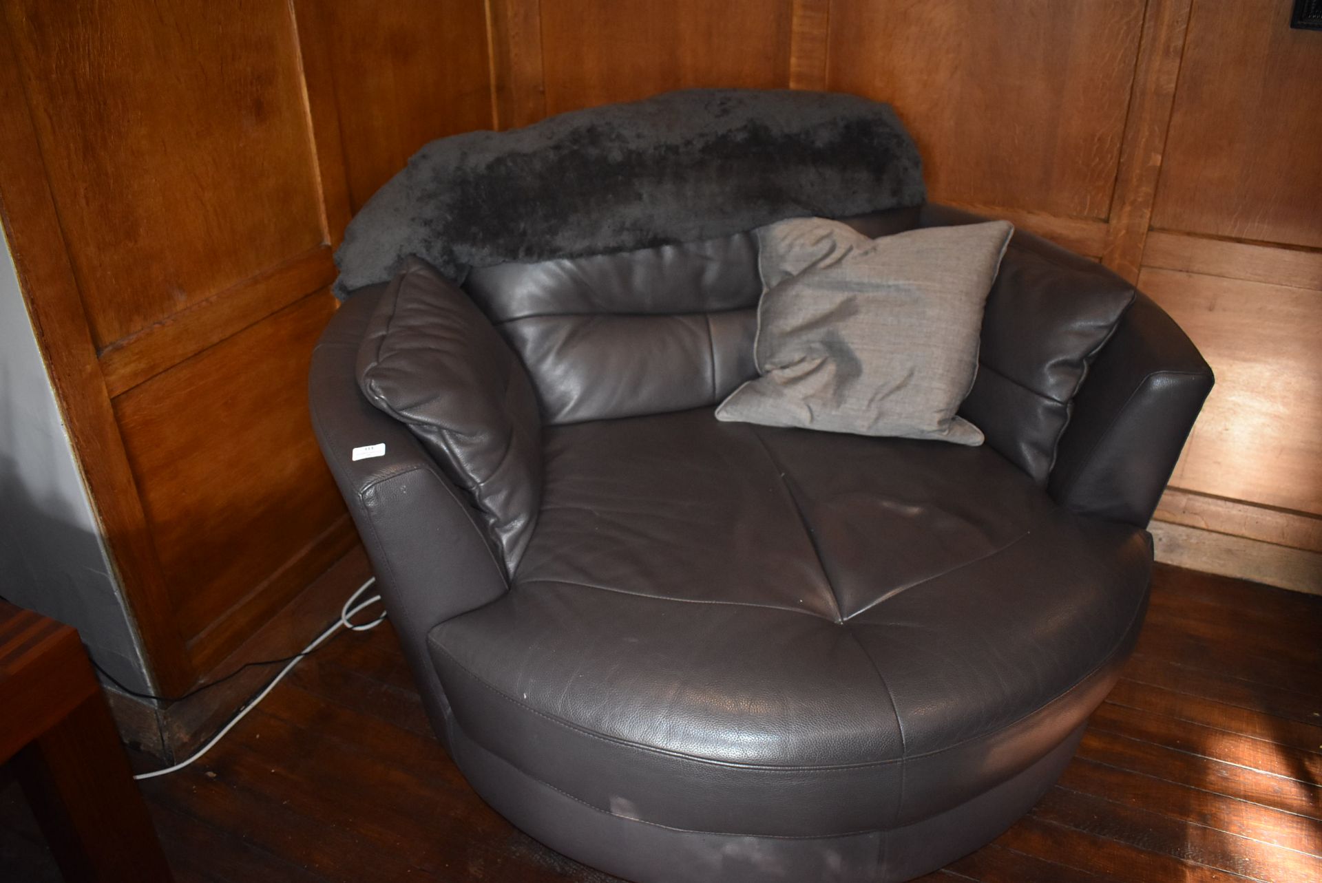 *Circular Swivel Grey Leather Chair with Throw and One Scatter Cushions
